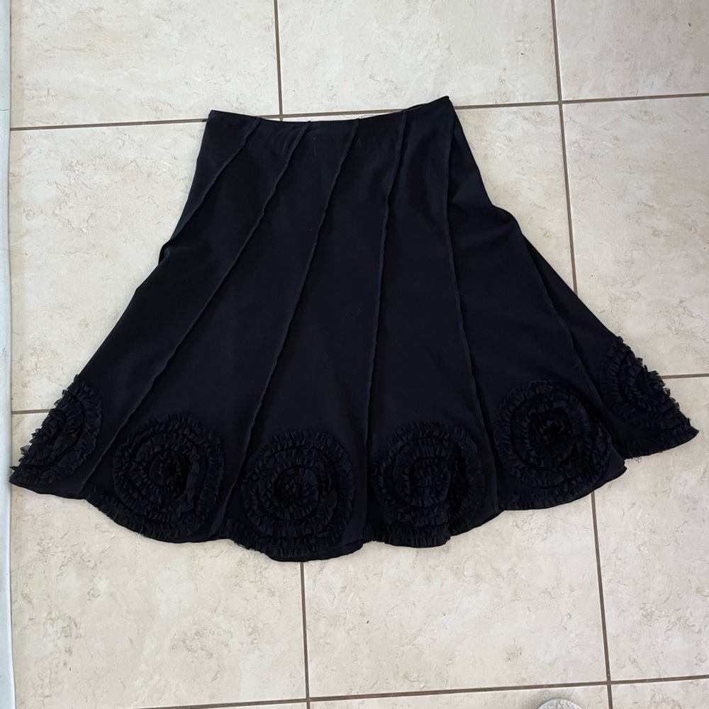 Sunny Leigh size 14 black skirt with cute flowerlike adornments at the bottom.
